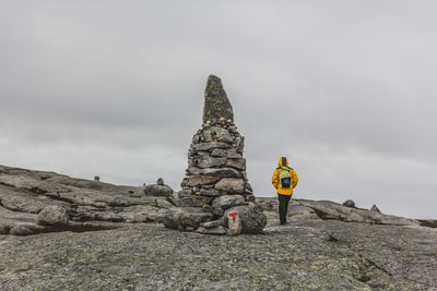 Gray sky walk beside the rock
